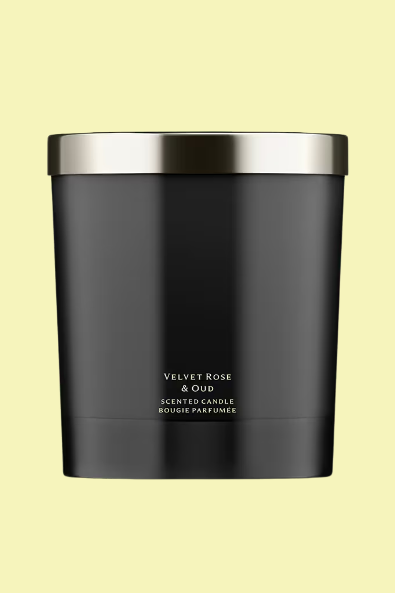 A black glass candle with a silver lid