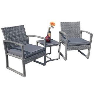 Grey wicker furniture set with two chairs and a small table