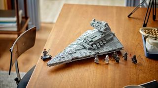 Lego Imperial Star Destroyer set and minifigures on a wooden table