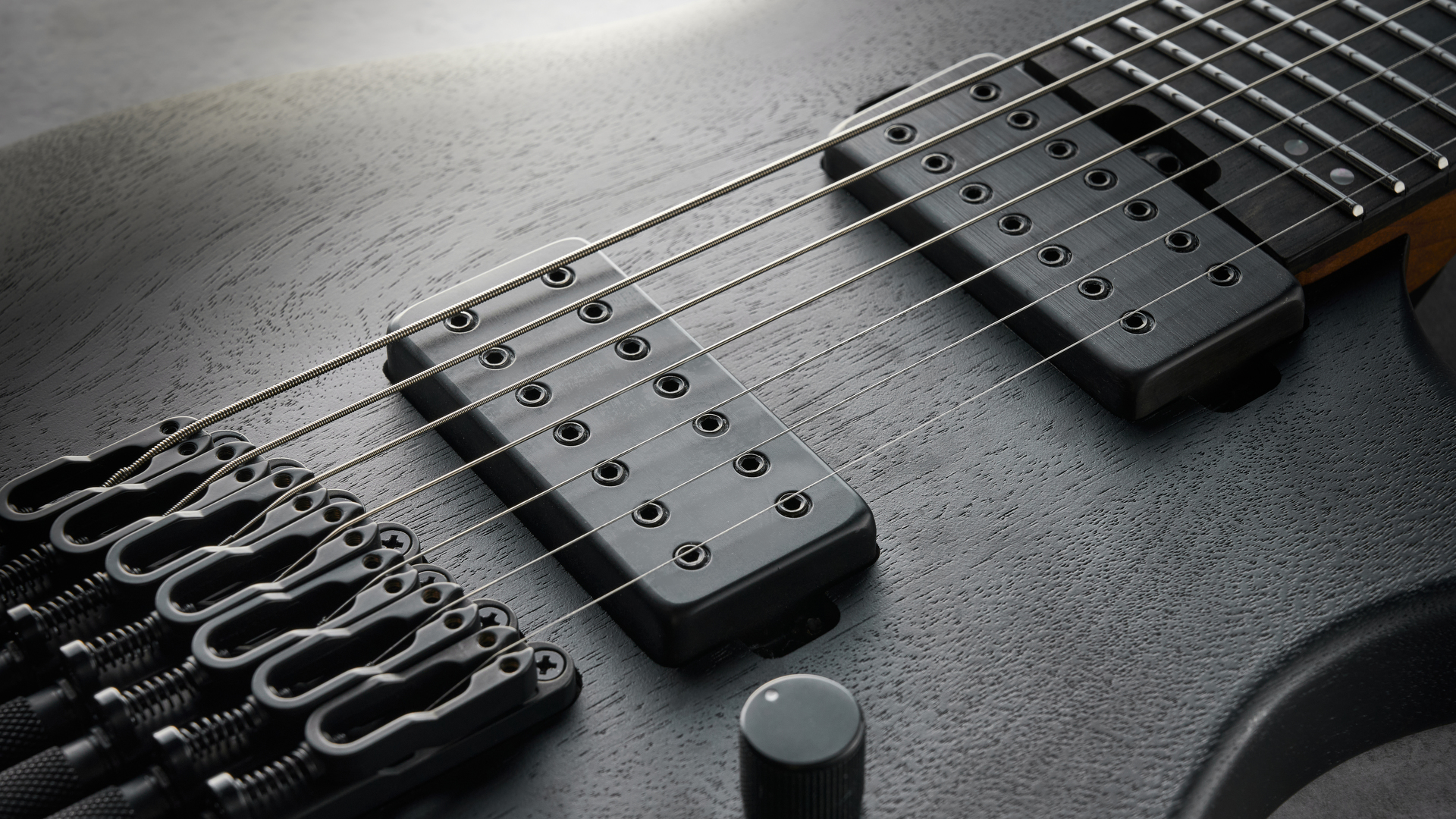 Ibanez QX527B headless guitar shot on grey surface