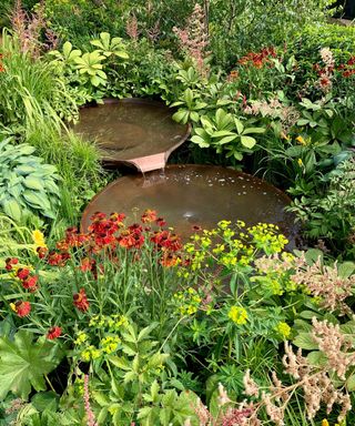 water bowls at 'RHS Planet-Friendly Garden' by Mark Gregory at Hampton Court Garden Festival 2022