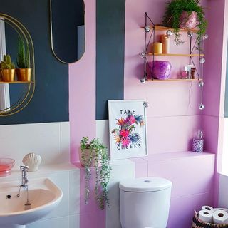 bathroom with candy-pink and dark blue colour combination and wall shelves