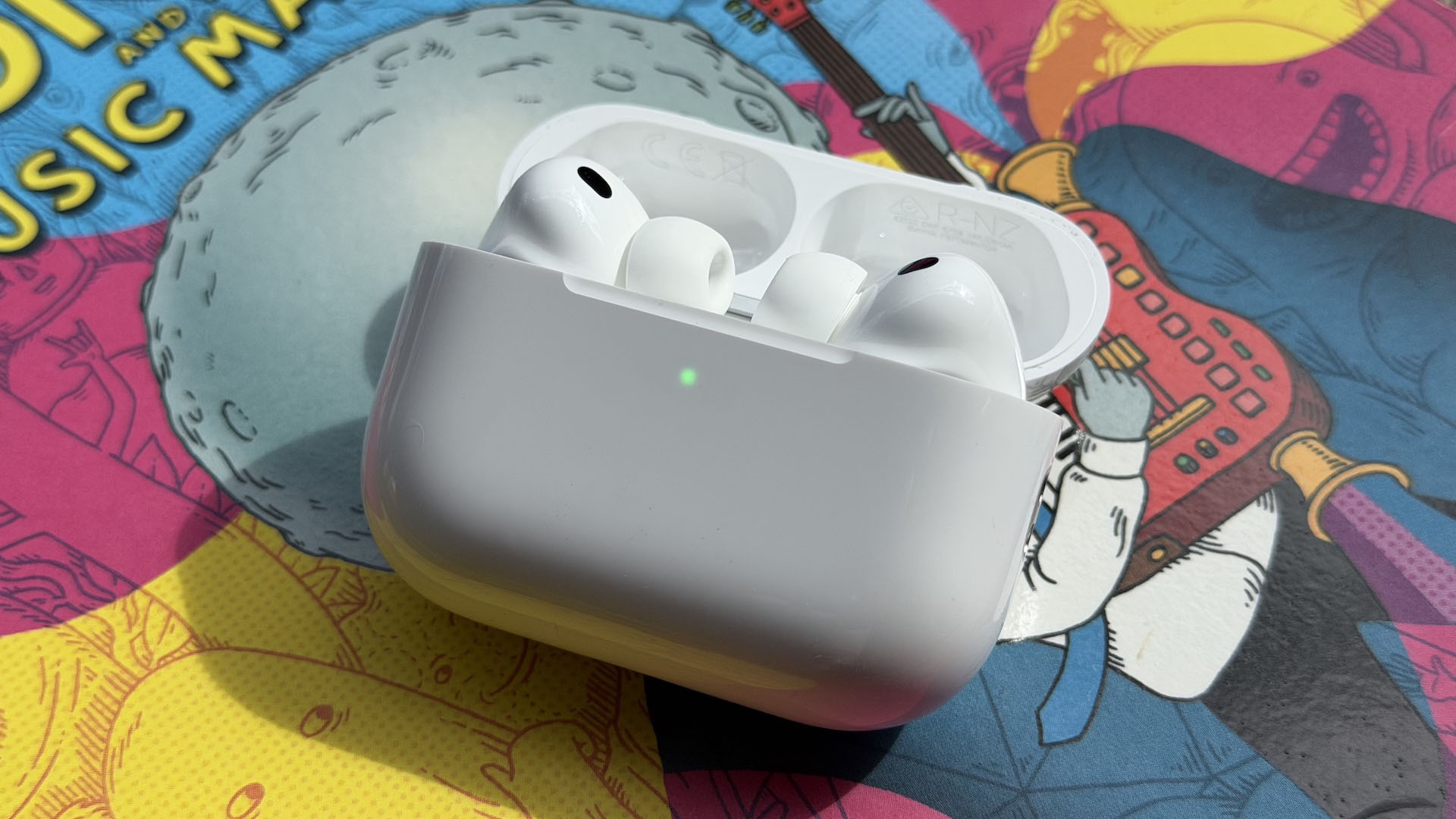 The AirPods Pro 3 earbuds from Apple against the pages of a graphic novel.