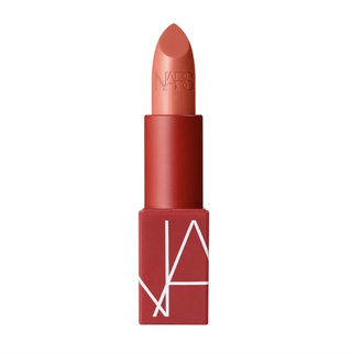 a tube of nars casablanca lipstick in front of a plain backdrop