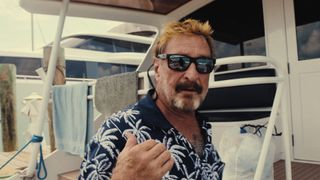 john mcafee in sunglasses on a boat