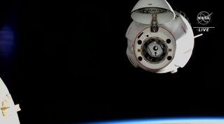spacex dragon at upper right with earth below