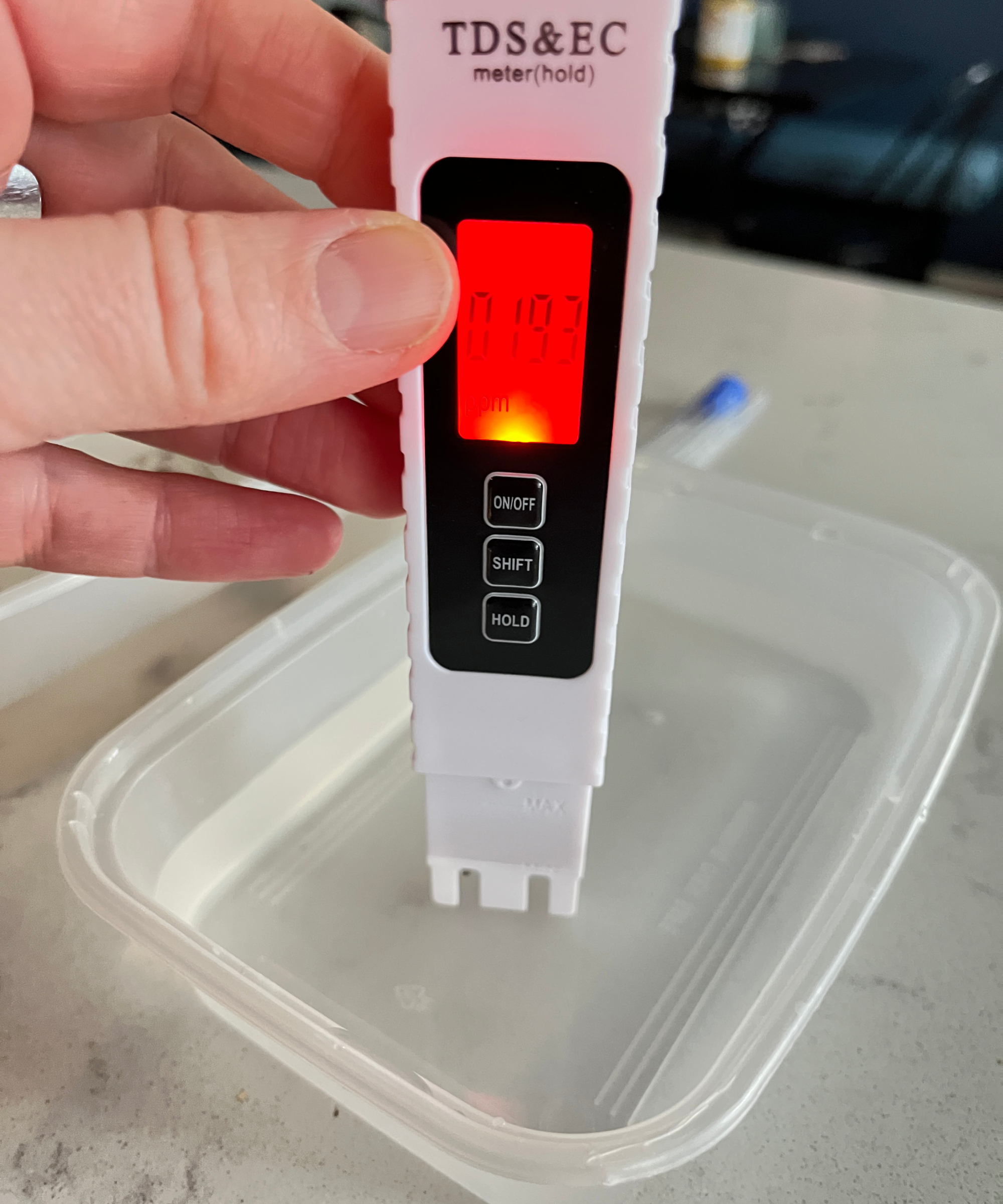 digital water tester placed in tub of clean water