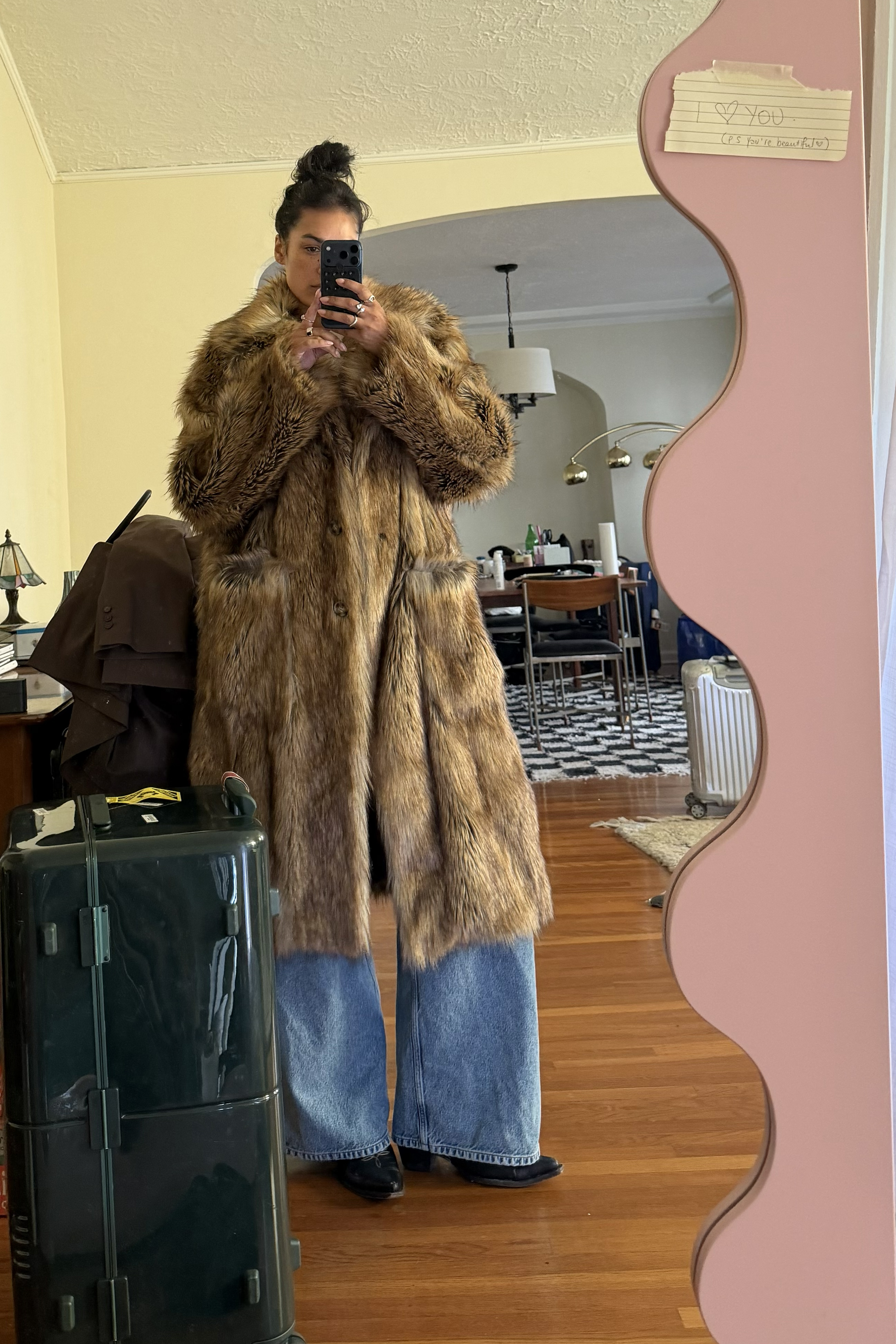 Jennifer Atilemile wearing a fur coat and jeans.