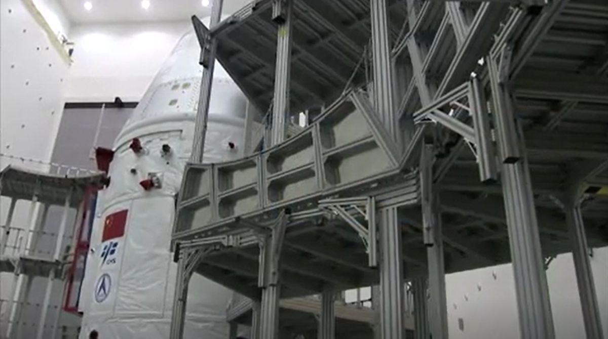 China's next-generation space capsule for astronauts is prepared for its uncrewed test flight on a Long March 5B rocket in these stills from a CCTV state news video. The capsule launched May 5, 2020.