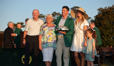 Rory McIlroy poses with the Masters trophy during the Green Jacket Ceremony alongside father Gerry, mother Rosie, wife Erica and daughter Poppy after winning the 2026 Masters Tournament