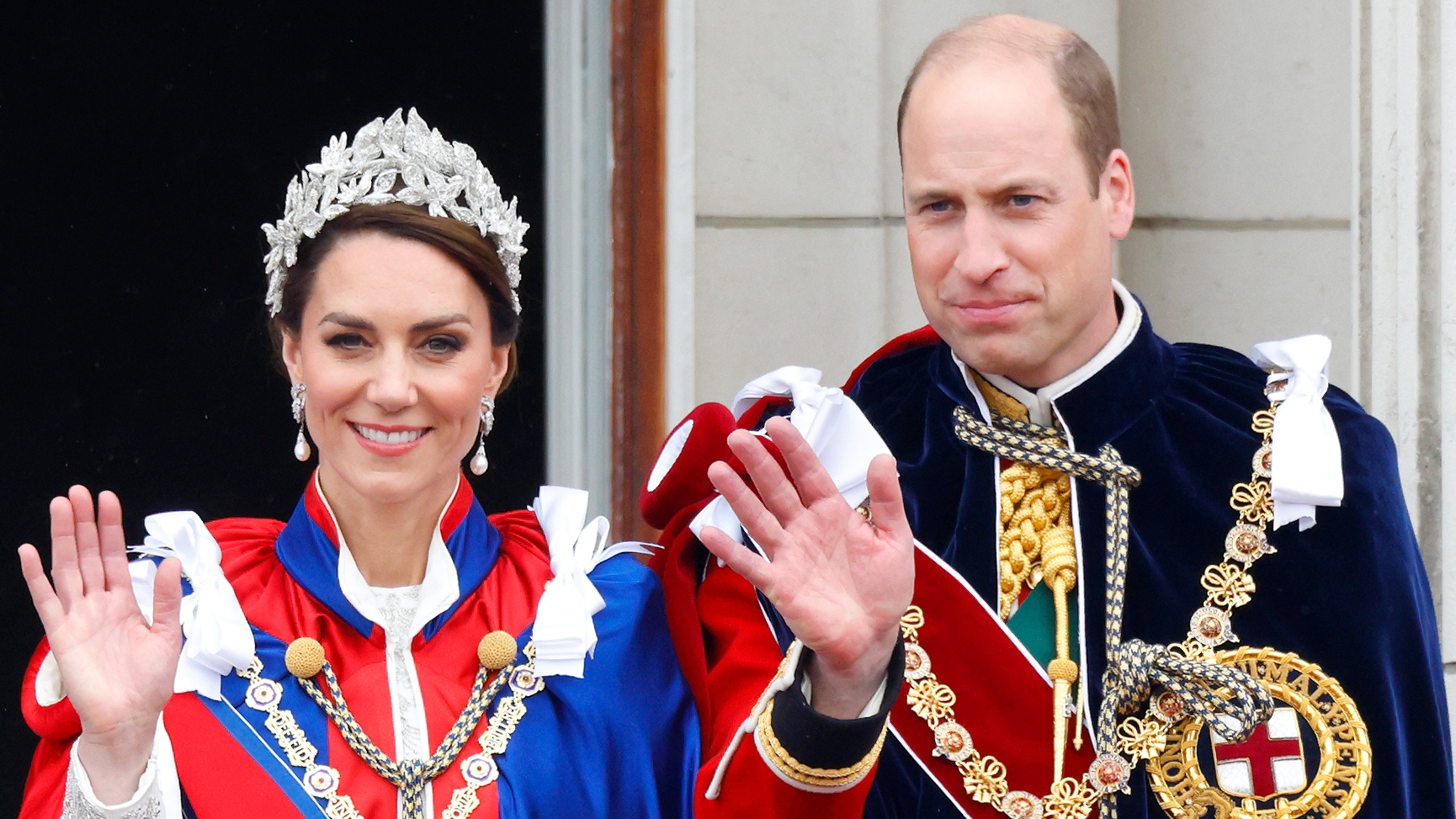 Catherine, Princess of Wales (wearing the Mantle of the Royal Victorian Order) and Prince William, Prince of Wales (wearing the Mantle of the Order of the Garter) wave and watch an RAF flypast from the balcony of Buckingham Palace