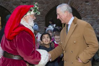 King Charles shaking hands with father Christmas