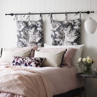 bedroom with white wall and black white cushion
