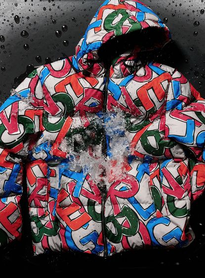 Colourful Herno Globe bomber jacket with letters being splashed with water