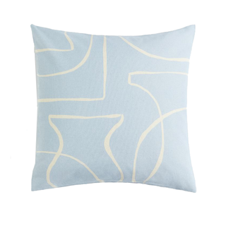 A light blue cushion cover with white abstract line work as a pattern