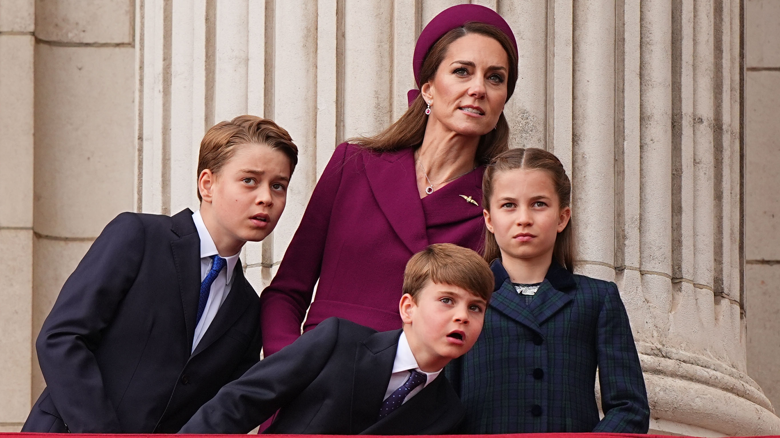 Prince George, Prince Louis, Catherine, Princess of Wales and Princess Charlotte watching the fly past at the end of the military procession for the 80th anniversary of VE Day