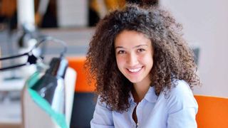 Smiling woman sat at desk