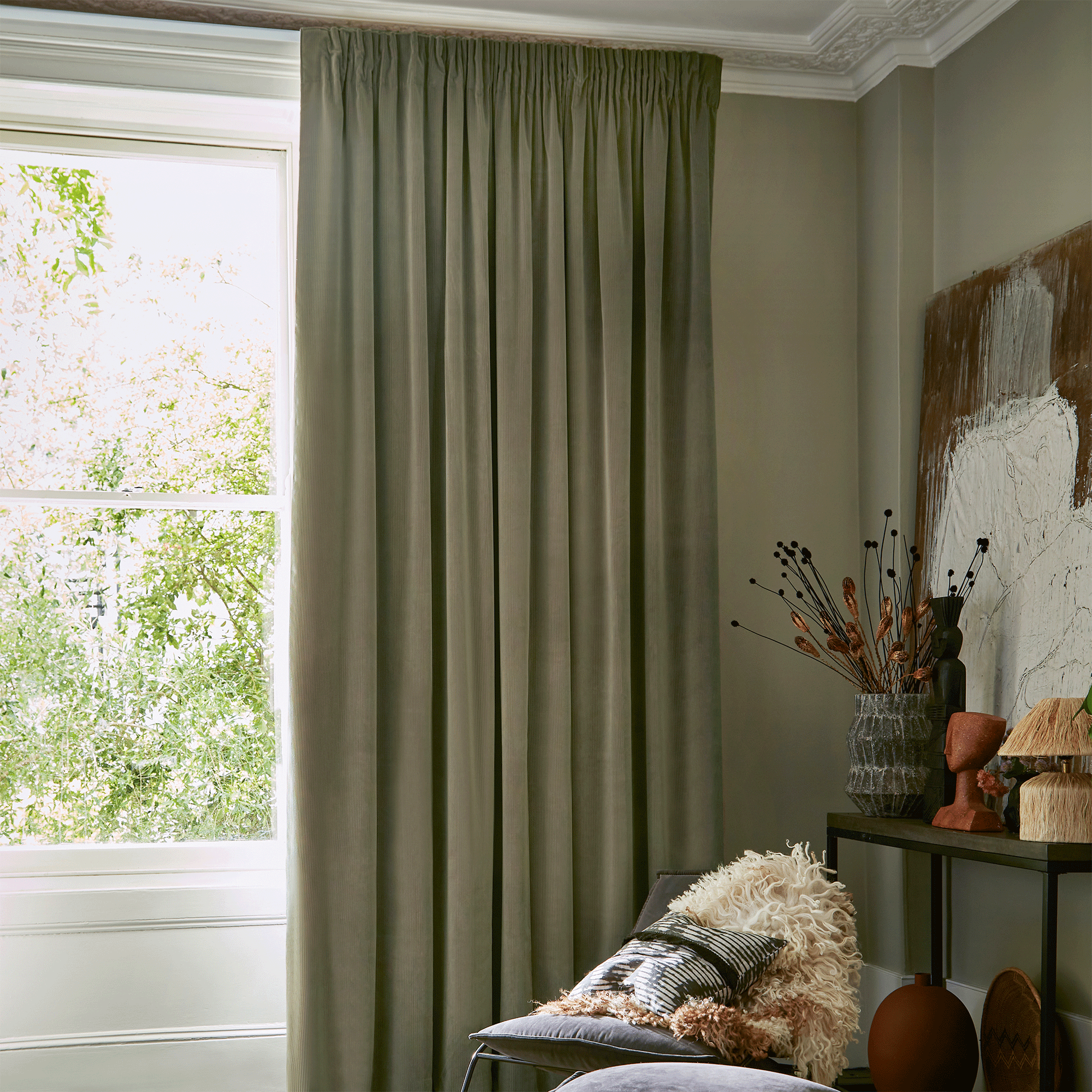 Green curtains in front of large window