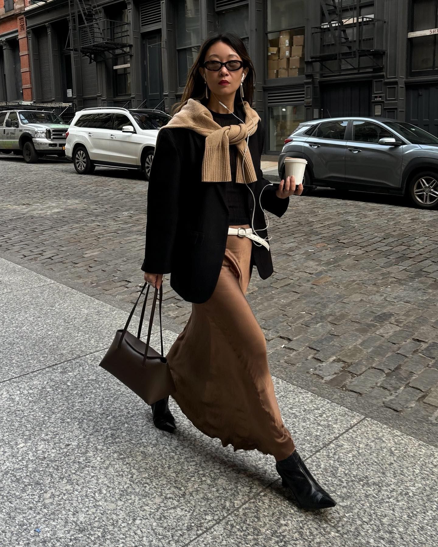 Stylish women wearing black and brown outfits