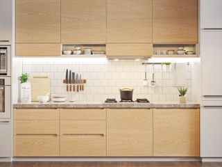 A blond wood kitchen with a wall-hung knife rack