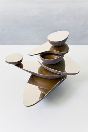 A stack of different shaped objects with mirrored surfaces