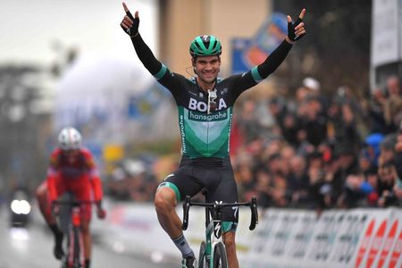 Max Schachmann raises his arms in celebration