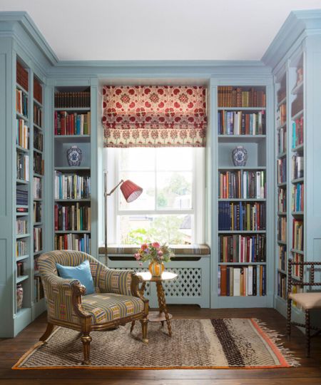 Library nook with blue fitted joinery and a patterned fabric blind. Interior by Kate Guinness, photograph James McDonald