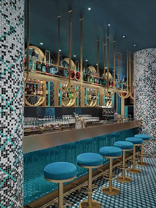 Liòn restaurant bar with teal and brass stools and circles of brass bar fixtures