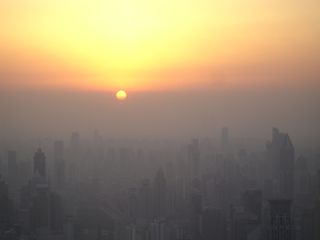 Shanghai before sunset in February 2008, seen from the Jin Mao tower observation deck. The sun has not yet dropped below the horizon; it has simply reached the smog line.