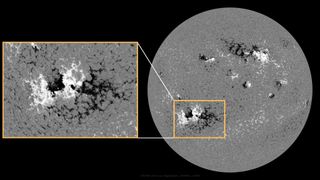 monochrome image of the surface of the sun with a small inset highlighting the magnetically complex sunspot region.