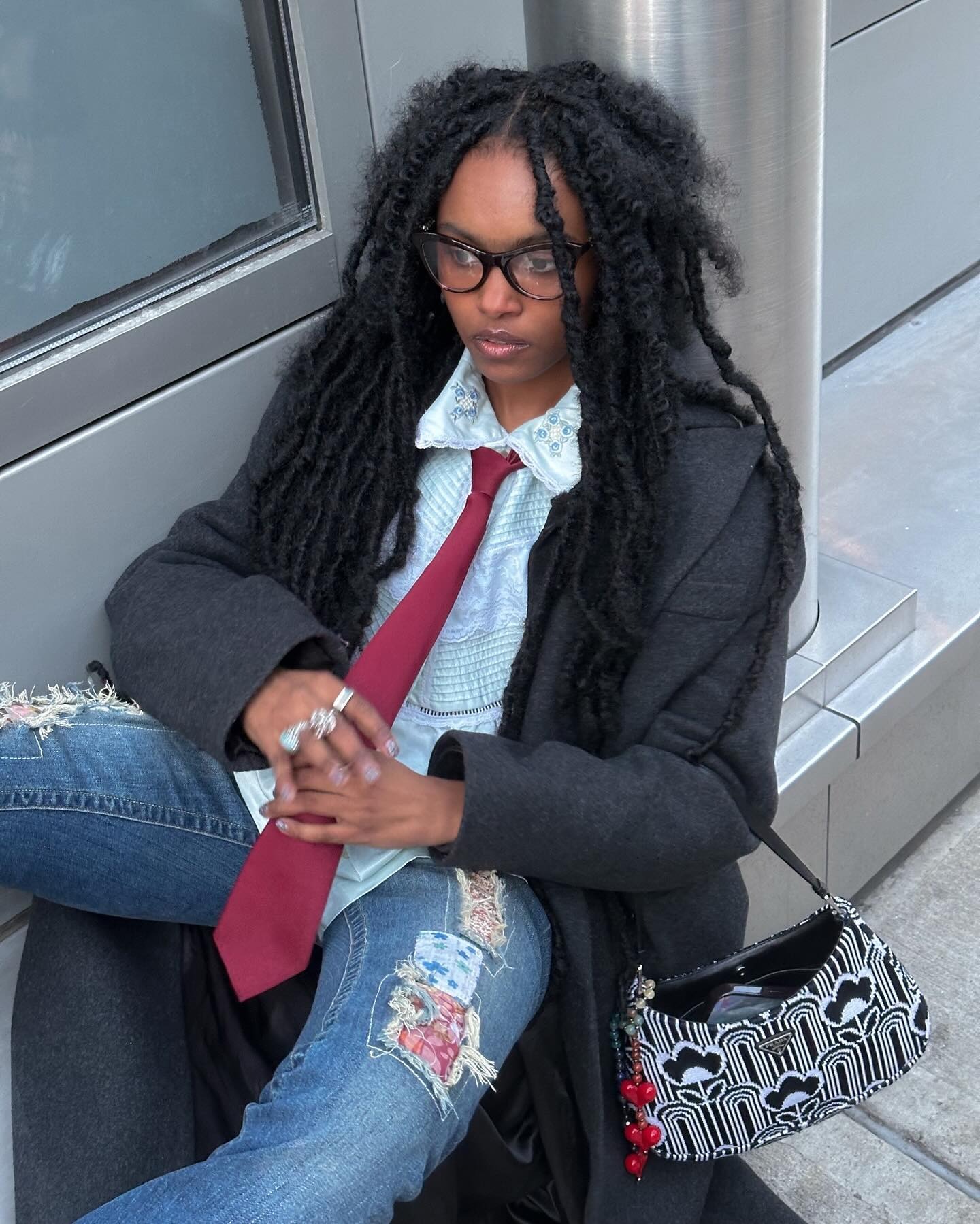 A woman with butterfly locs and natural texture.