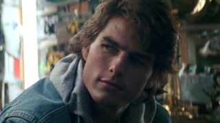 Cole Trickle in denim jacket talking to Harry in Days of Thunder