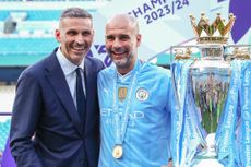 Khaldoon Al Mubarak chairman of Manchester City poses for a photo with the trophy with Pep Guardiola 