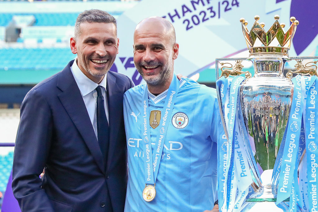 Khaldoon Al Mubarak chairman of Manchester City poses for a photo with the trophy with Pep Guardiola 