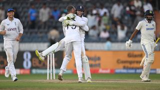 England wicketkeeper Ben Foakes celebrates with Tom Hartley after taking the final wicket to beat India