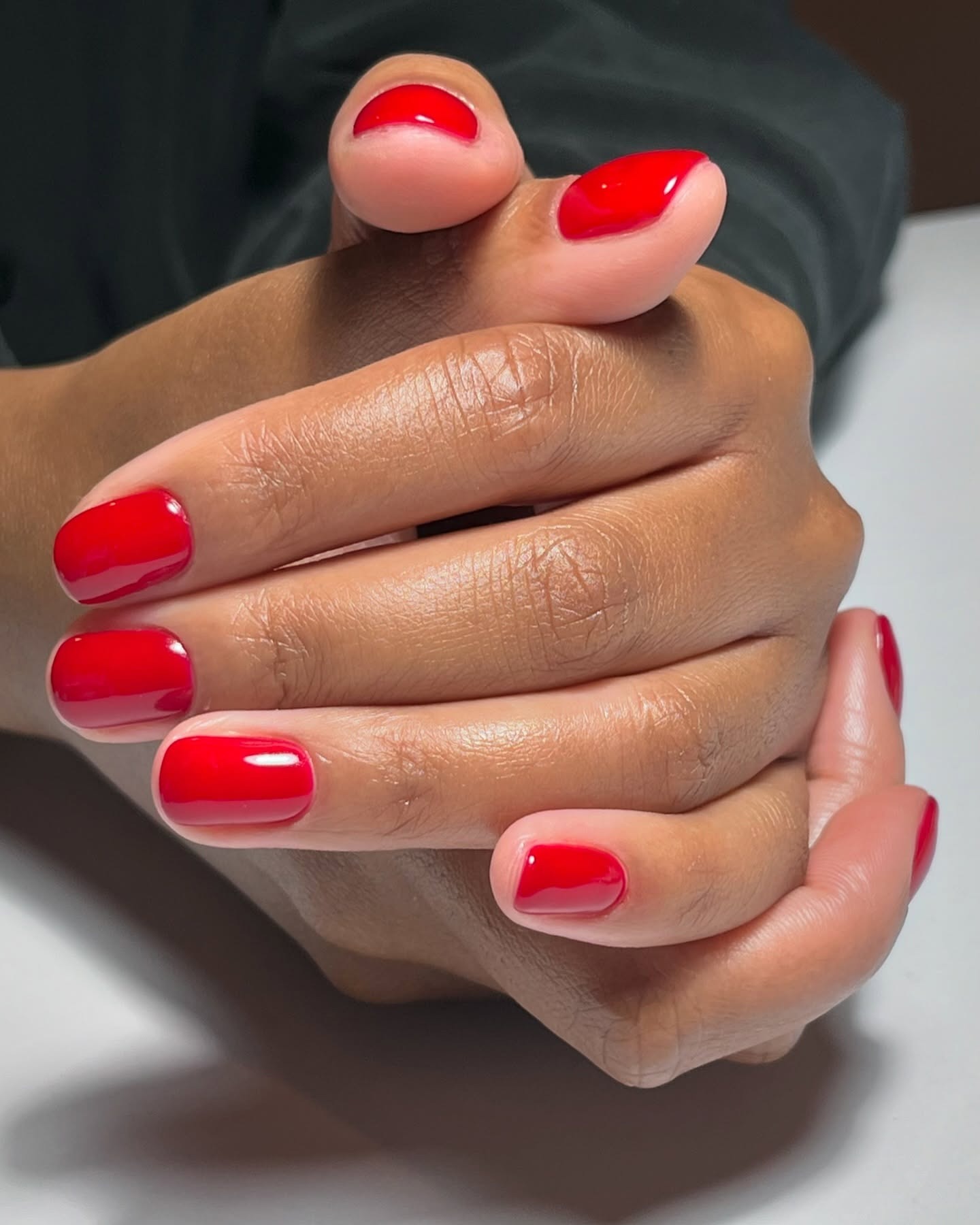 A short, bright red manicure