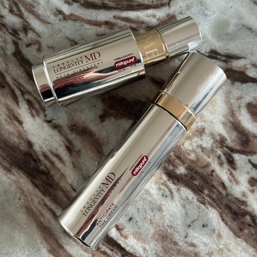 The Lancome Anticipate cream and serum on a marble table