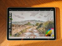 Photos of a white drawing tablet on a wooden table, the XPPen Magic Pro 13