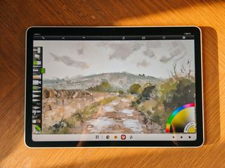 Photos of a white drawing tablet on a wooden table, the XPPen Magic Pro 13