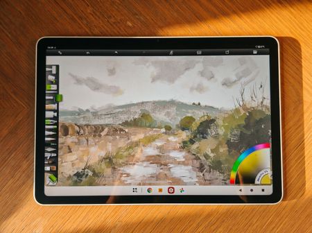 Photos of a white drawing tablet on a wooden table, the XPPen Magic Pro 13