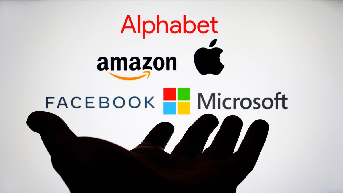 Big tech companies over top of a hand