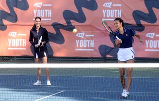 Catherine, Duchess of Cambridge and British US Open champion Emma Raducanu in action at the LTA's National Tennis Centre