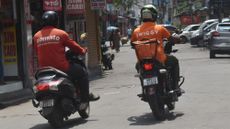 Drivers for the Indian food delivery startups Zomato and Swiggy are seen in Kolkata, India, in 2024.