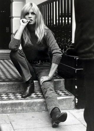 Brigitte Bardot sitting on the stairs