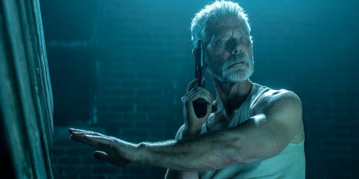 Stephen Lang feeling his surroundings, with a gun in his hand, in Don&#039;t Breathe.