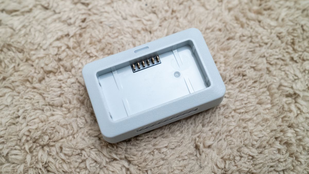 Holy Stone HS360E drone battery charger on a beige carpet