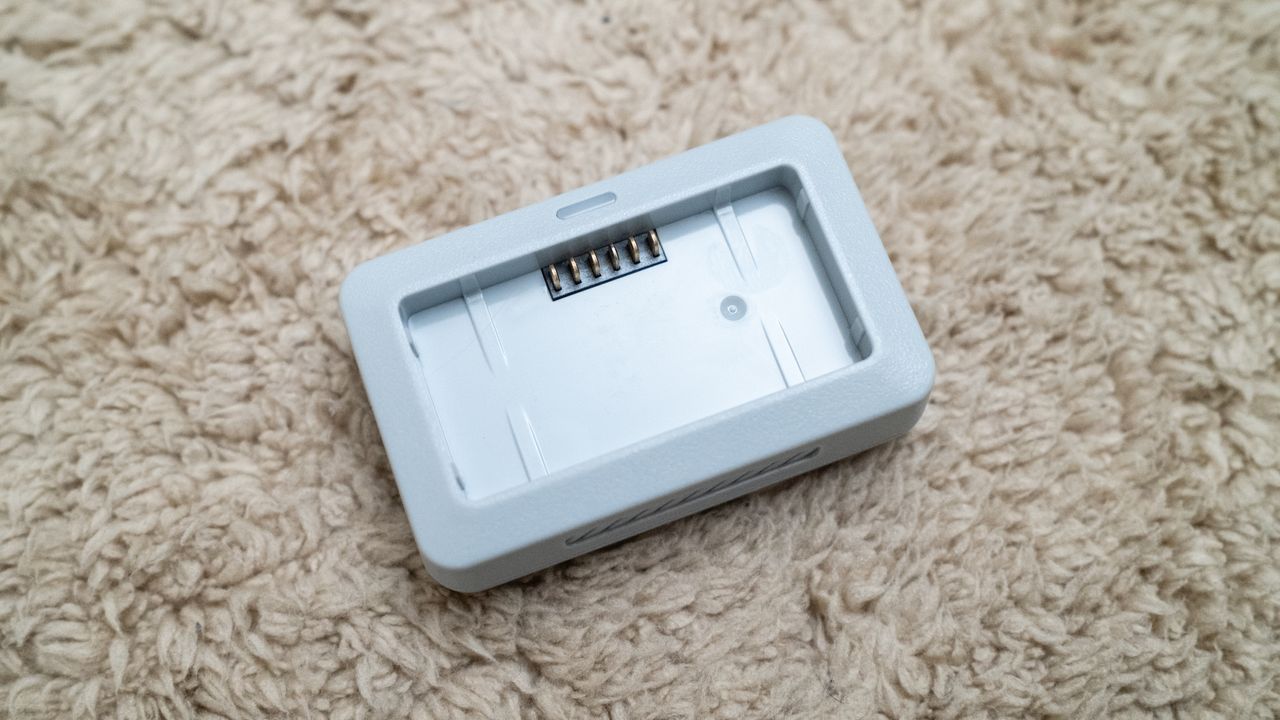 Holy Stone HS360E drone battery charger on a beige carpet