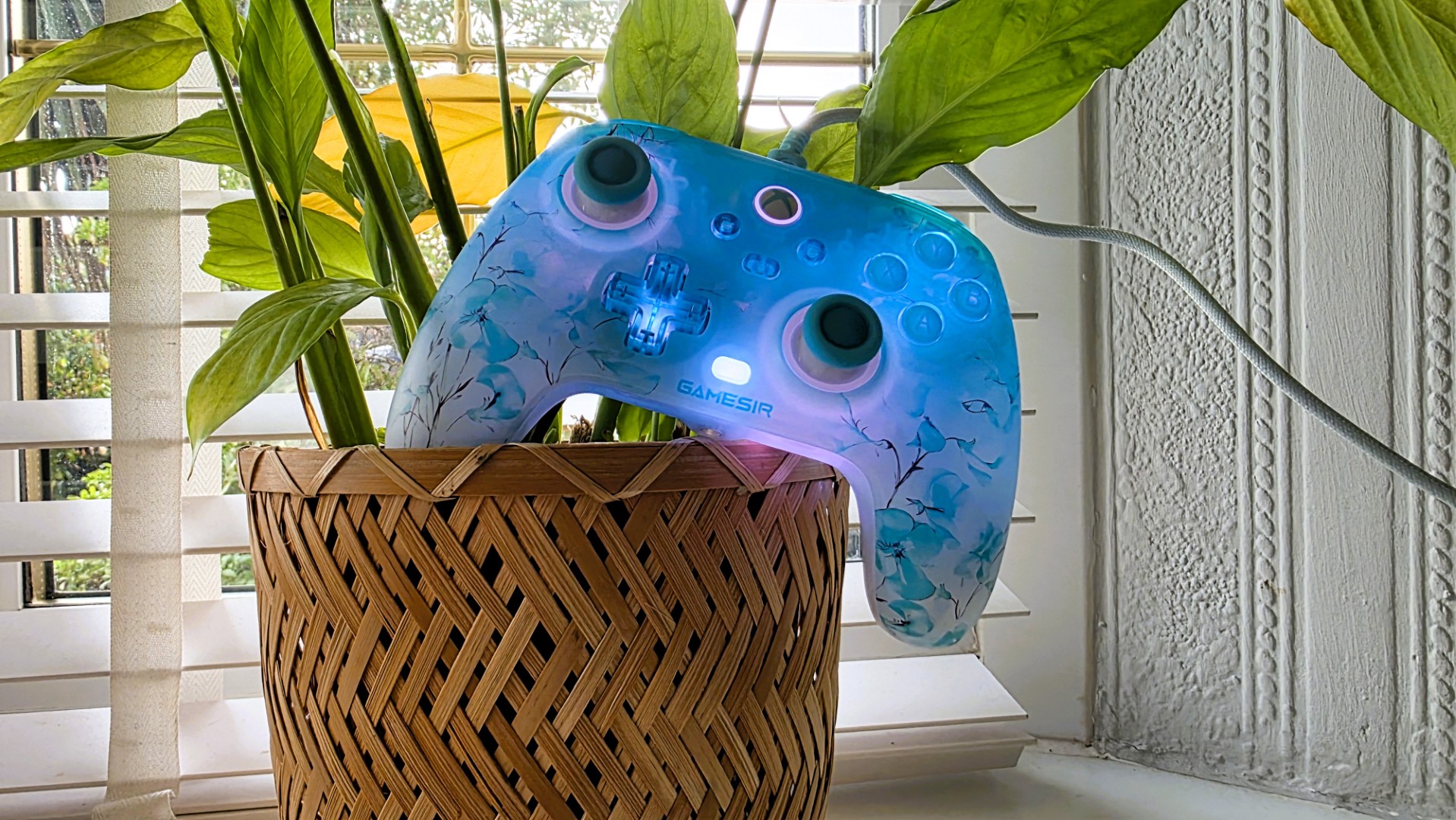 A blue and white controller with floral pattern