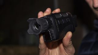 A angular view of the Rexing B1 Basic night vision monocular in a male's hands