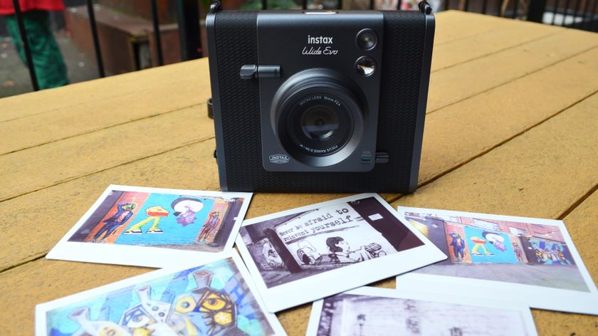 A black and gray Fujifilm Instax Wide Evo hybrid instant camera